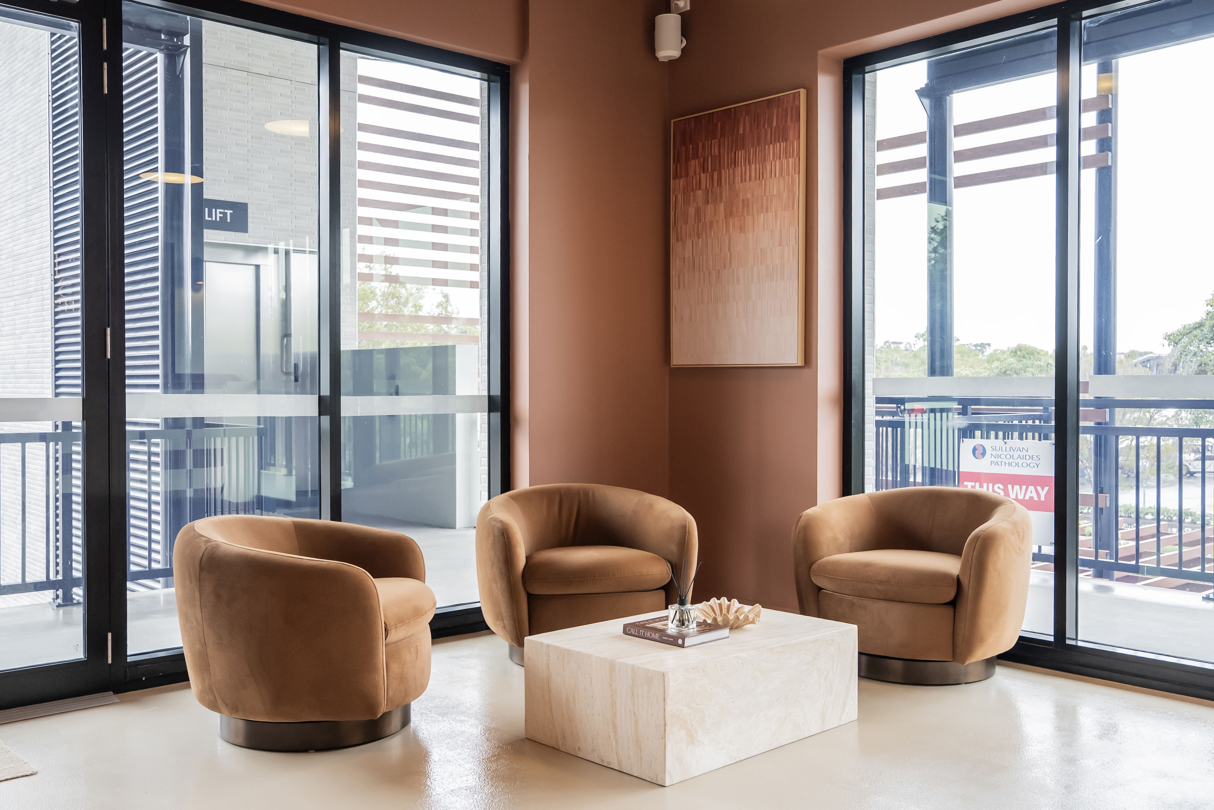 Sunlit waiting area with armchairs at Square Recovery Noosa