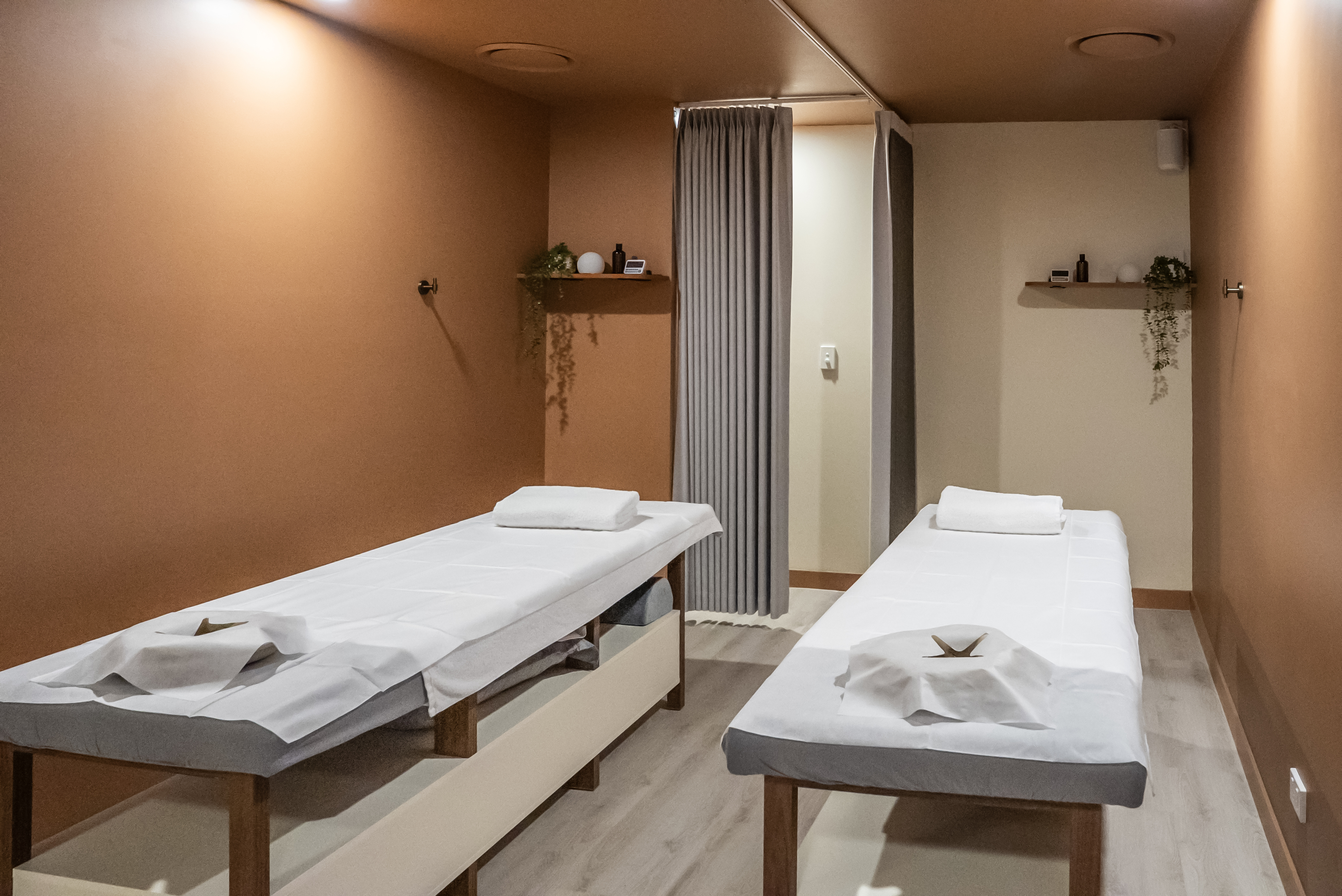Two prepared massage tables in a private treatment room at Square Recovery Noosa