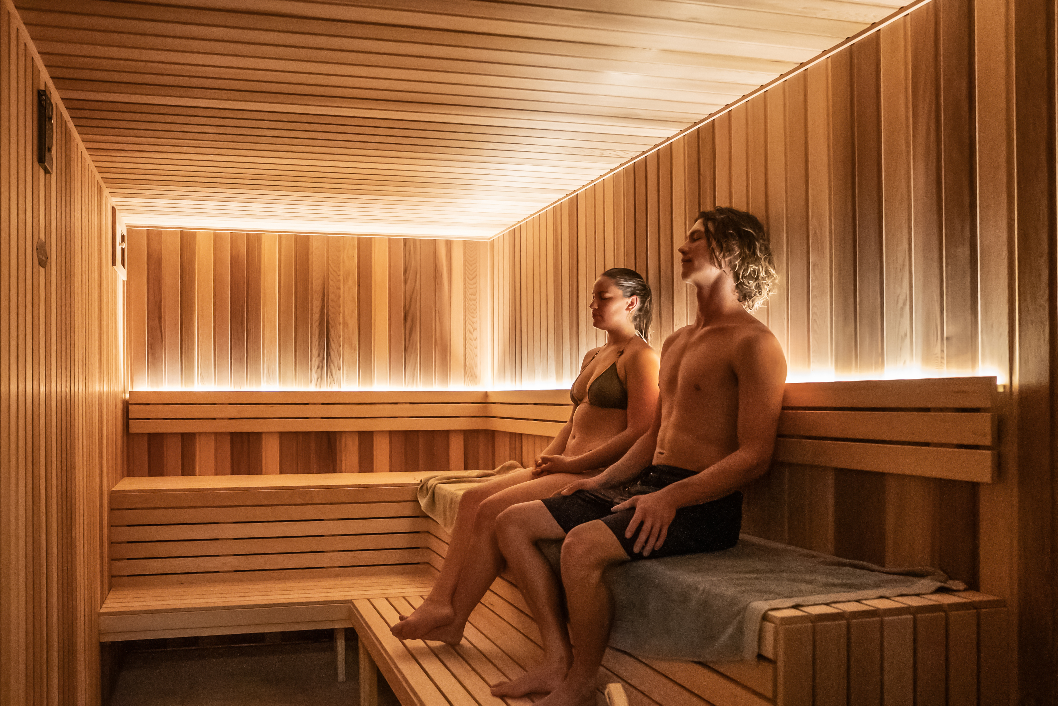 Guests relaxing in the timber sauna at Square Recovery Noosa